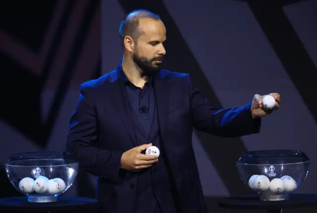 Magician Mario Daniel performs ahead of the draw