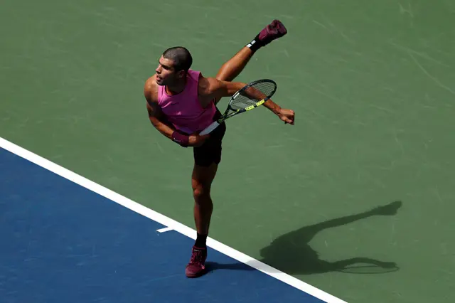 Carlos Alcaraz serves