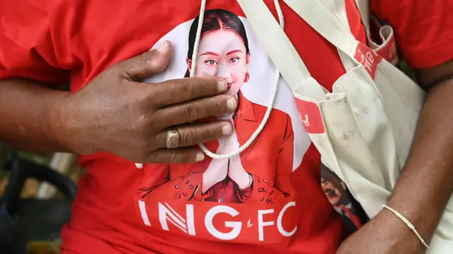 Close-up of a supporter's red shirt printed with a photo of Paetongtarn