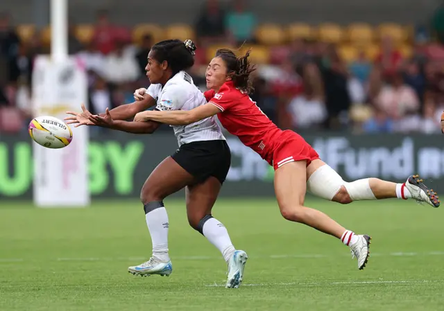 Fiji's Manuqalo Komaitai is tackled by Florence Symonds of Canada