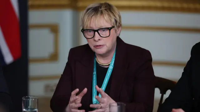 Angela Eagle speaks at a roundtable meeting with a Union Jack to the side