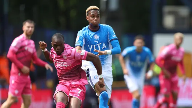 Carlos Mendes Gomes of Bolton Wanderers and Malik Mothersille of Stockport County