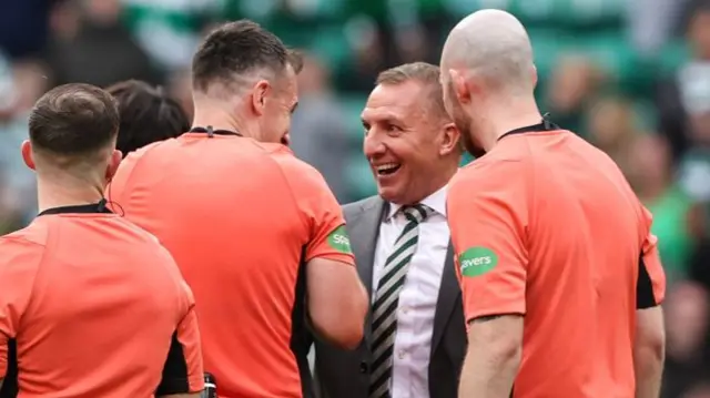 Brendan Rodgers jokes with the officials