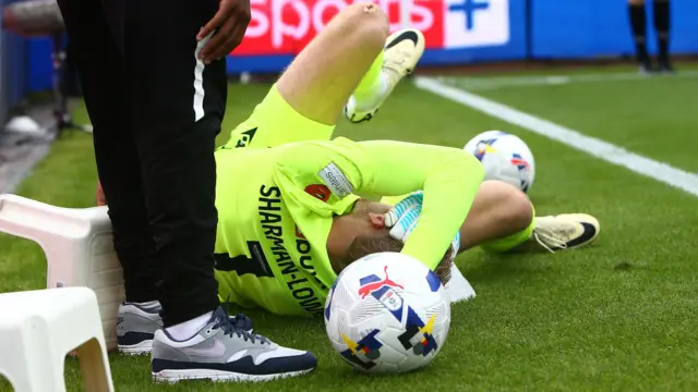 Teddy Sharman-Lowe holds his head