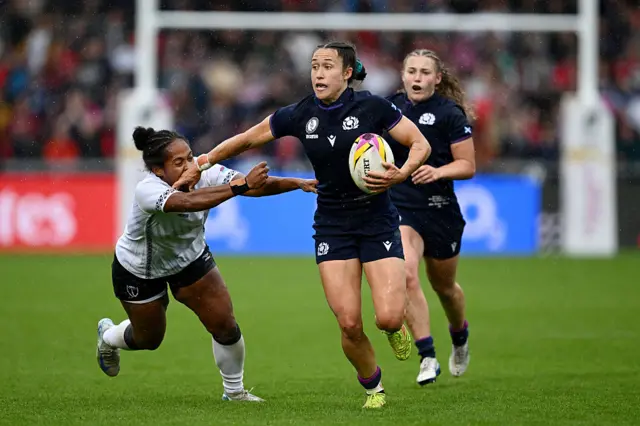 Rhona Lloyd hands off a defender