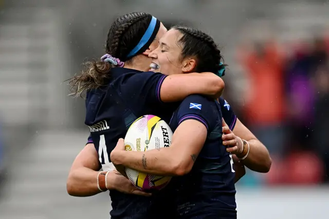 Rhona Lloyd celebrates her try with Emma Wassell