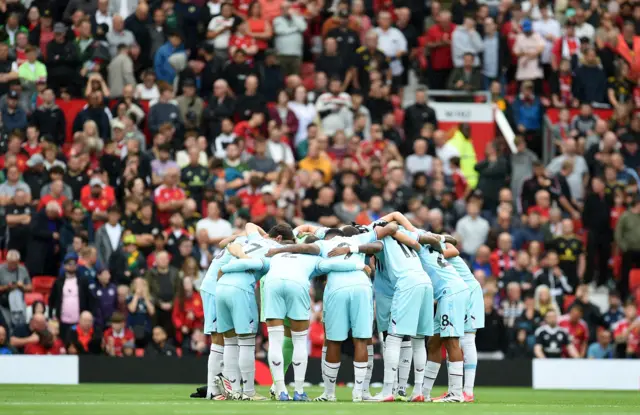 Burnley players huddle before the match.