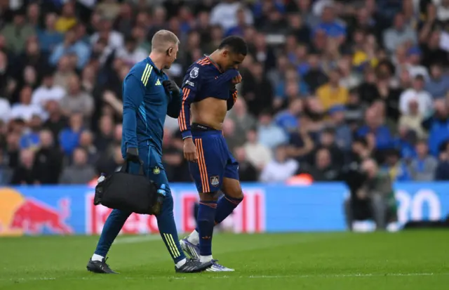 Newcastle United's Jacob Ramsey receives medical attention