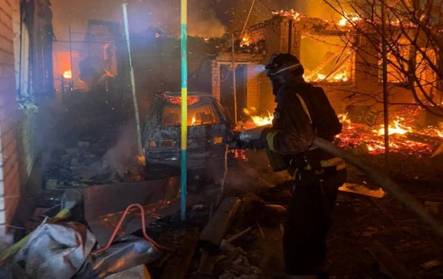 A firefighter works at the site of an apartment building hit during a Russian drone and missile strike in Zaporizhzhia
