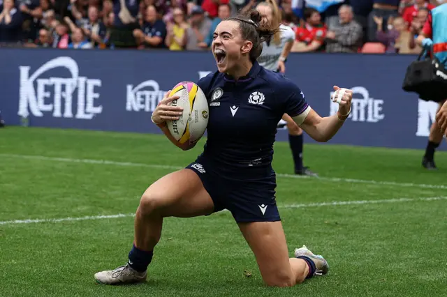Francesca McGhie celebrates on of her tries against Wales