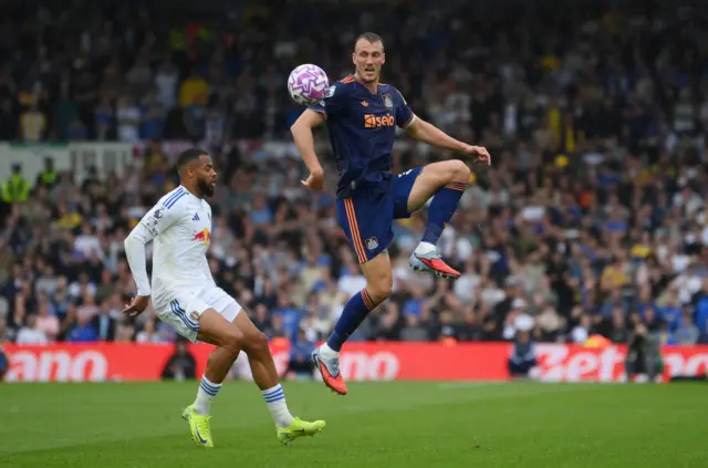 Newcastle United's Dan Burn in action with Leeds United's Lukas Nmecha