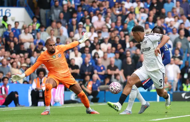 Fulham's Rodrigo Muniz in action with Chelsea's Trevoh Chalobah and Robert Sanchez