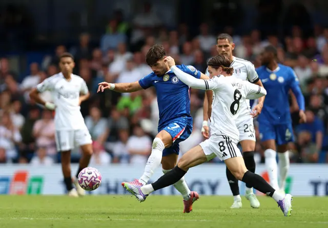 Pedro Neto of Chelsea is challenged by Harry Wilson of Fulham during the Premier League match between Chelsea and Fulham at Stamford Bridge on August 30, 2025 in London, England.
