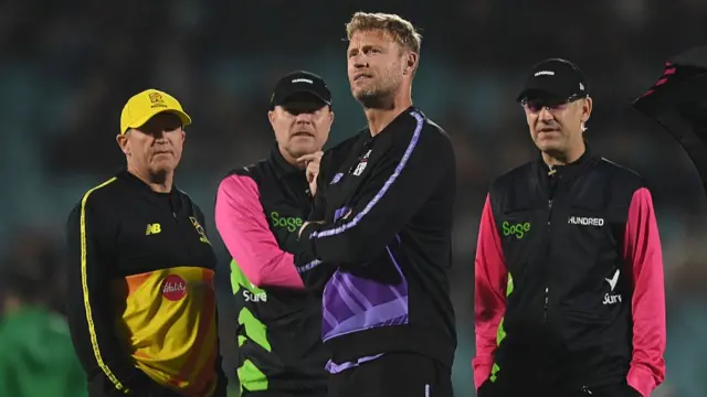 Andy Flower (L) of Trent Rockets and Andrew Flintoff of Northern Superchargers meet with the umpires