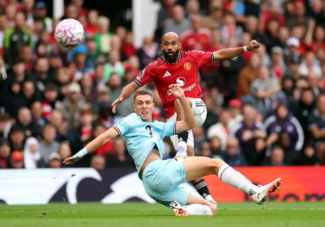 Bryan Mbeumo of Manchester United shoots whilst under pressure from Maxime Esteve of Burnley during the Premier League match between Manchester United and Burnley at Old Trafford on August 30, 2025 in Manchester, England.