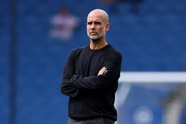 Pep Guardiola, Manager of Manchester City, looks on