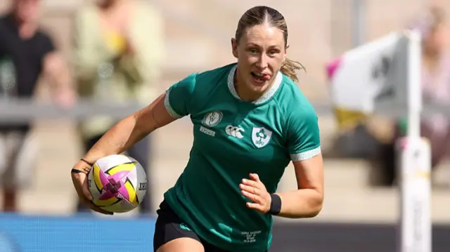 Anna McGann of Ireland scores her team's seventh try