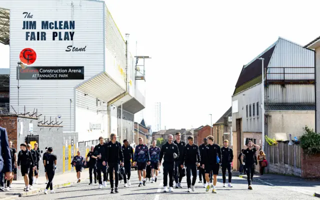 Dundee United players walk to Dens Park