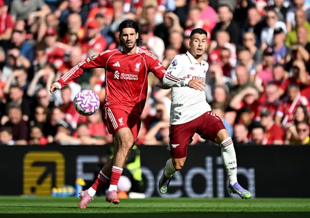 Dominik Szoboszlai of Liverpool challenges Gabriel Martinelli of Arsenal