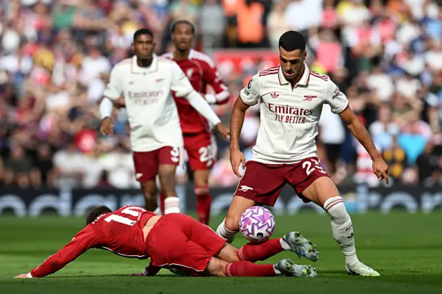 Mikel Merino of Arsenal tackles Alexis Mac Allister