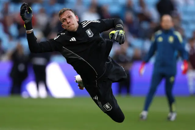 Bizot dives to make a save in the warm up