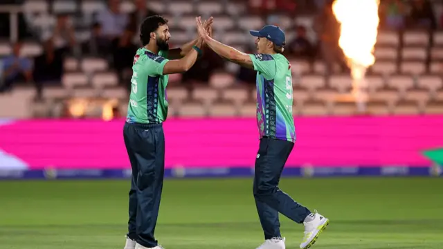 qib Mahmood celebrates with teammate Tom Curran after taking the wicket of Ross Whiteley