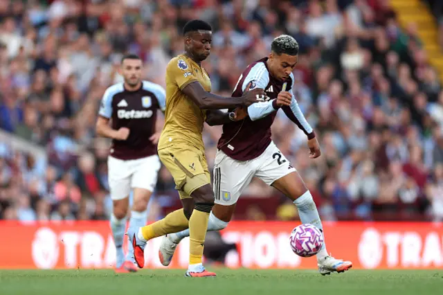 Morgan Rogers of Aston Villa is challenged by Marc Guehi