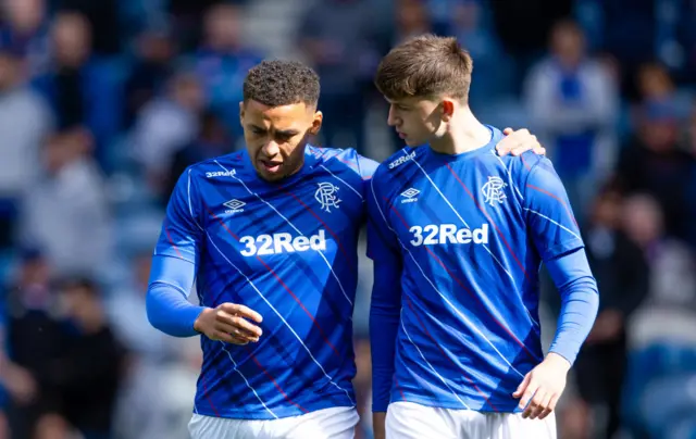 Rangers captain James Tavernier shares a word with teenager Mikey Moore