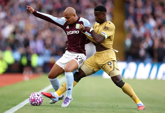 Donyell Malen of Aston Villa is challenged by Marc Guehi of Crystal Palace