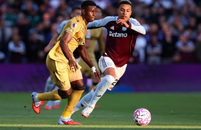 Crystal Palace's Marc Guehi in action with Aston Villa's Morgan Rogers