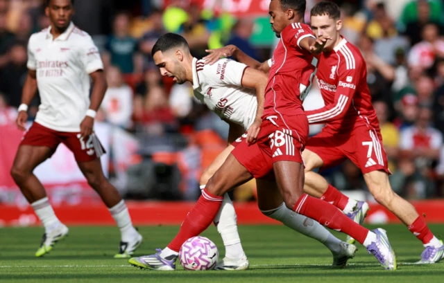 Arsenal's Mikel Merino in action with Liverpool's Ryan Gravenberch
