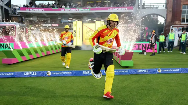 Tom Banton and Joe Root of Trent Rockets walk out to bat