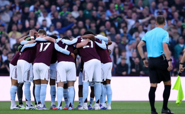Aston Villa players huddle before the match