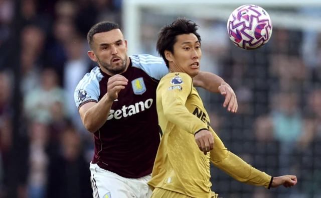 Aston Villa's John McGinn in action with Crystal Palace's Daichi Kamada