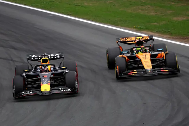 Lando Norris passes Max Verstappen around the outside
