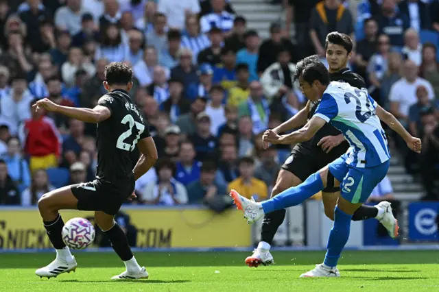 Kaoru Mitoma (R) has this shot saved