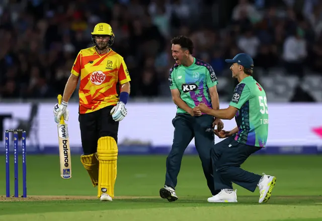 Nathan Sowter of Oval Invincibles celebrates with teammate Tom Curran after taking the wicket of Joe Root