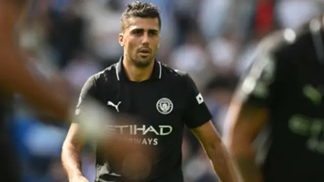 Rodri looks on