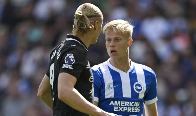 Brighton & Hove Albion's Jan Paul van Hecke and Manchester City's Erling Haaland clash