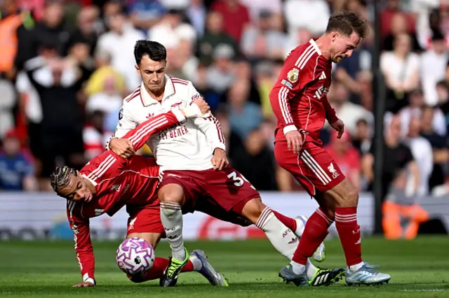 Martin Zubimendi of Arsenal is challenged by Hugo Ekitike