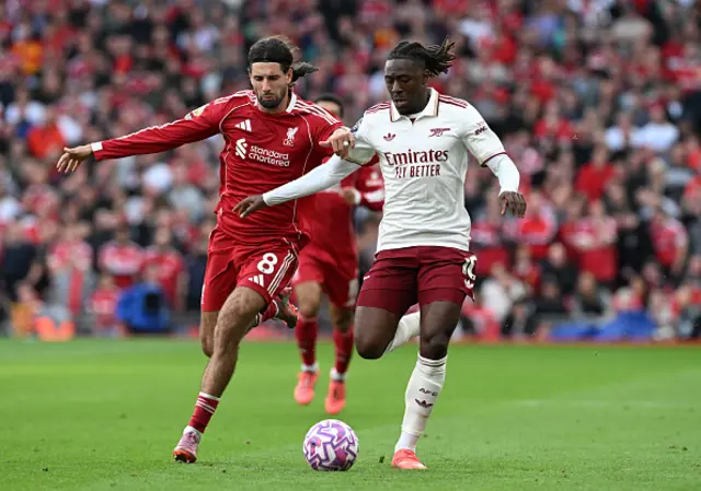 Dominik Szoboszlai of Liverpool challenges Eberechi Eze