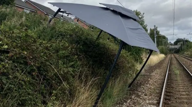 A gazebo blown onto the railway tracks in Merseyside