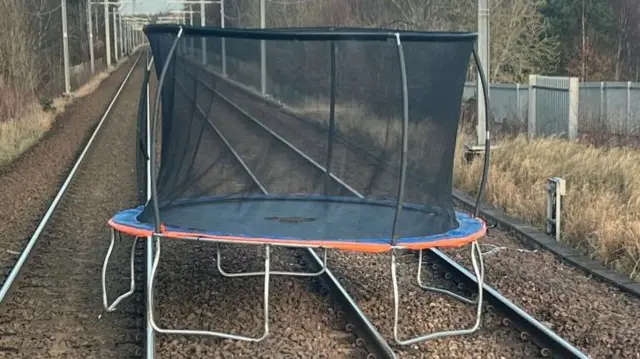 Trampoline on railway tracks.