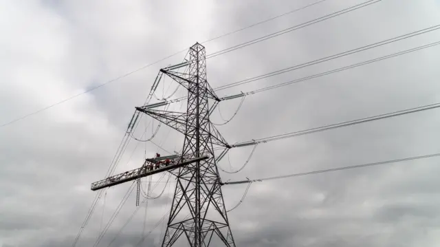 Engineers working on an electricity pylon.