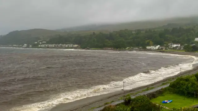Brown sea and grey skies over coastline in Dunoon