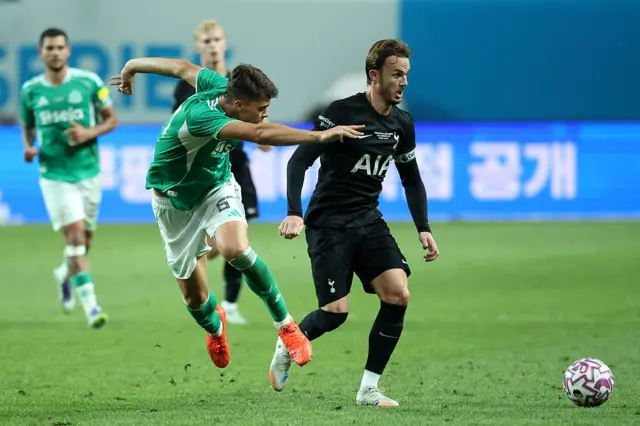 James Maddison of Tottenham Hotspur is challenged by Lewis Miley of Newcastle
