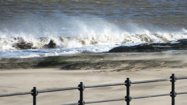 Waves crashing onto sand.