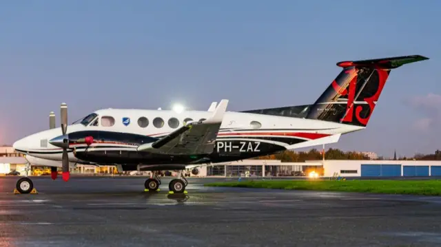 A plane sits on a runway.