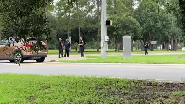 Law enforcement officers stand on a street corner in Georgia.