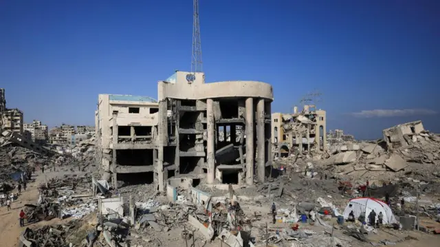 A photograph from today of the damage clinic with its communications mast and UN crest